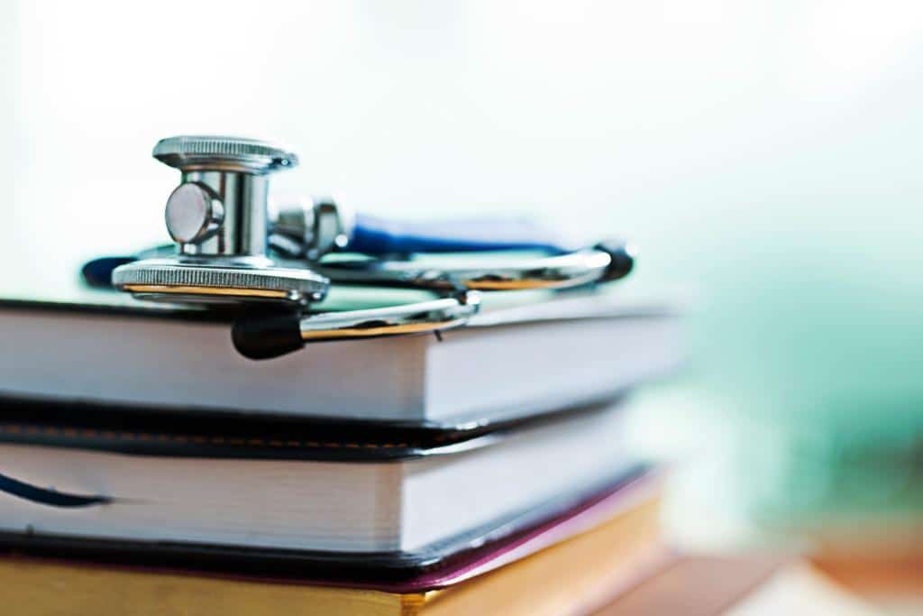 Medical stethoscope on a pile of books