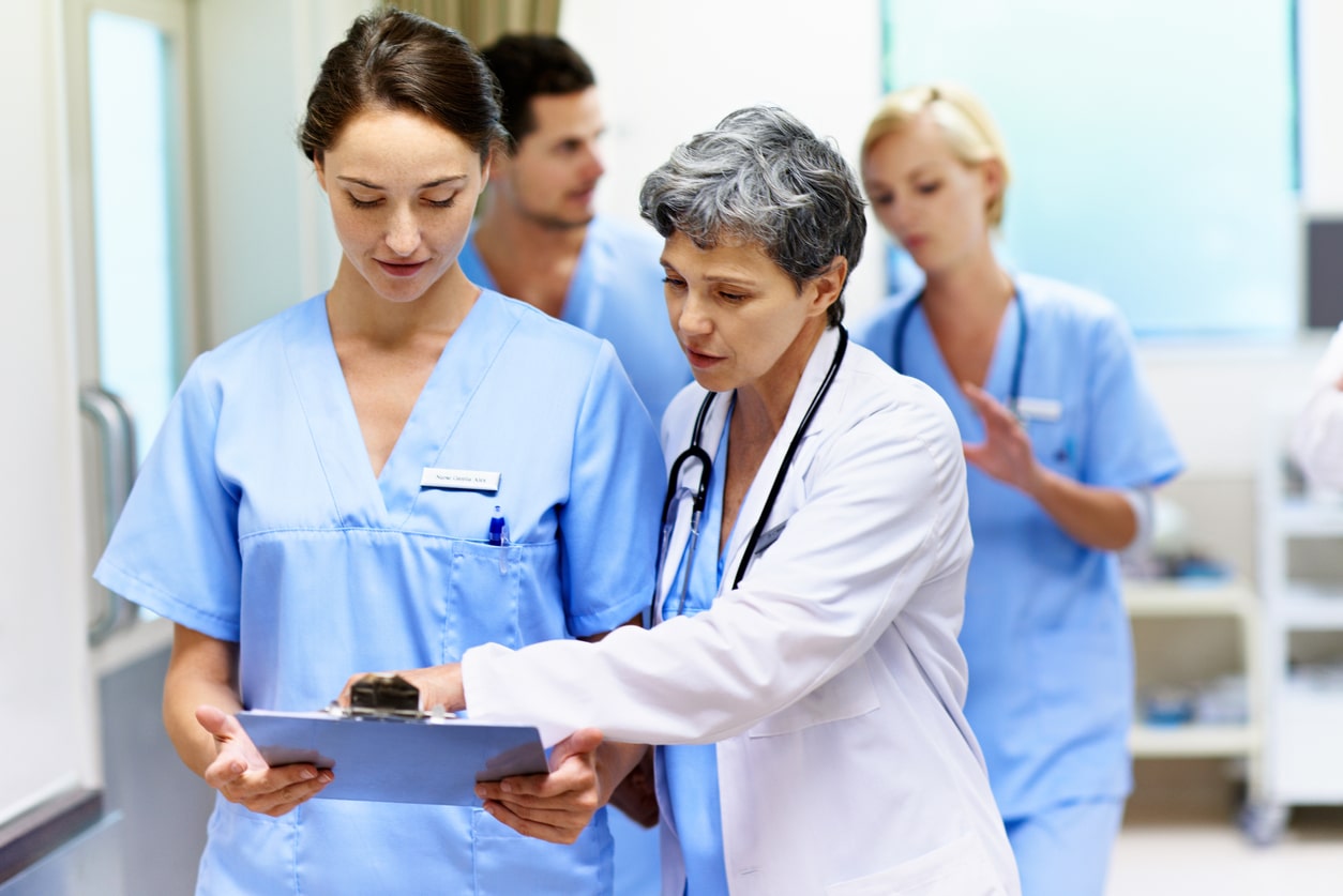 team of doctors walking and talking in a hospital 