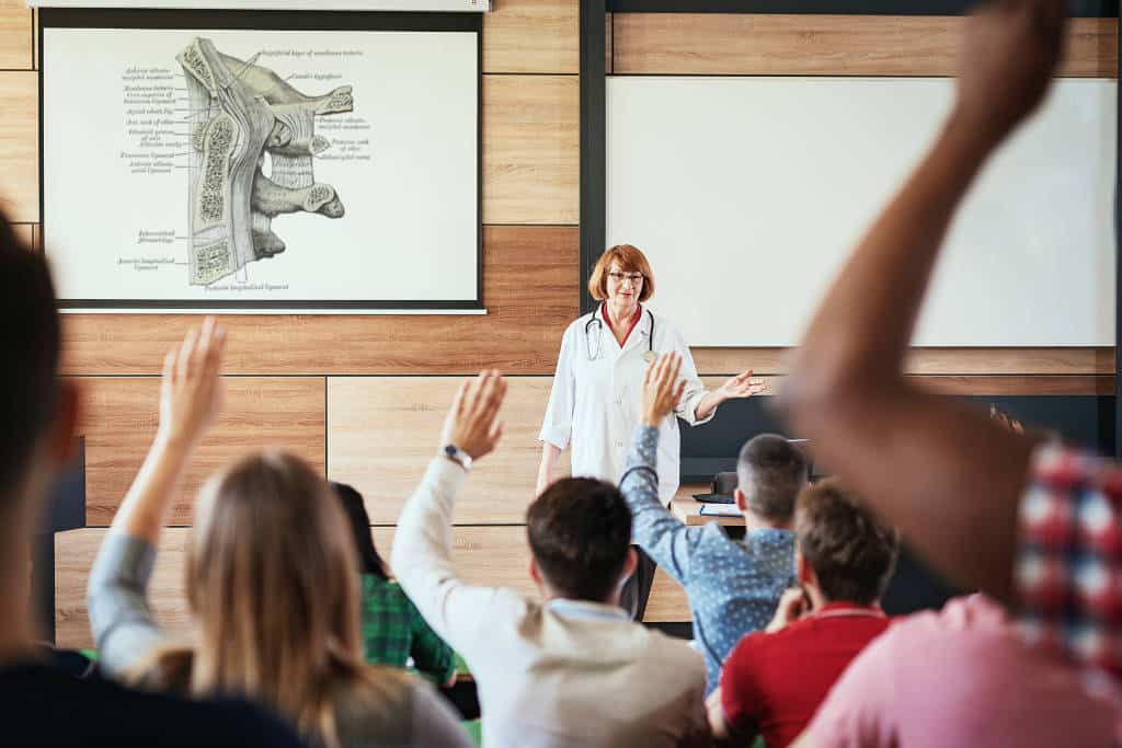 University students listening to the lectures in the lecture hall, enjoying the classes and teamwork