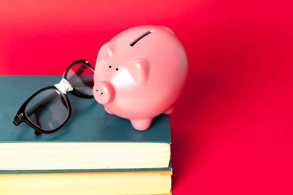 piggy bank on a stack of book concept of education costs