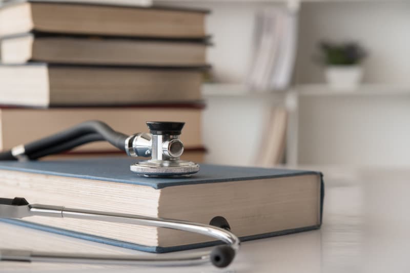 medical textbook Stethosocpe and book indicate what to do if your MCAT has been cancelled.